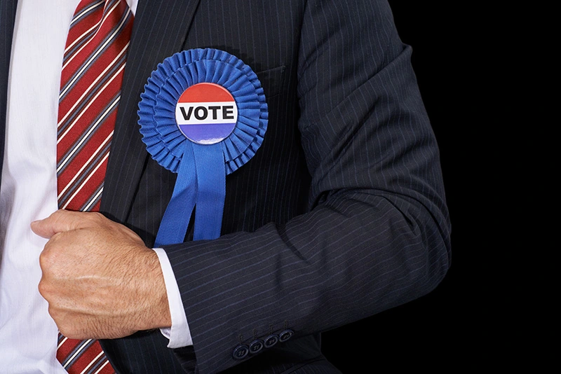 A rosette with the word vote on it